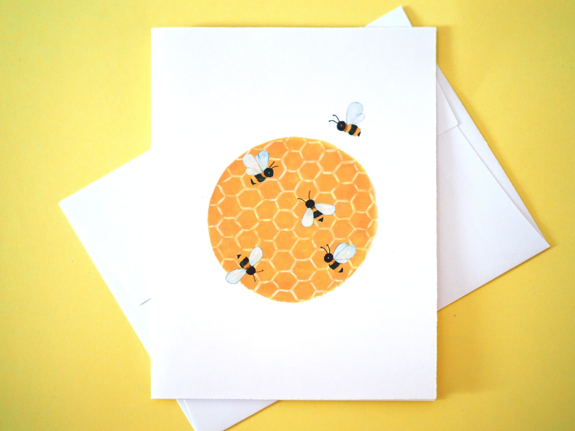 Greeting card with honeycomb and bees design on a yellow background