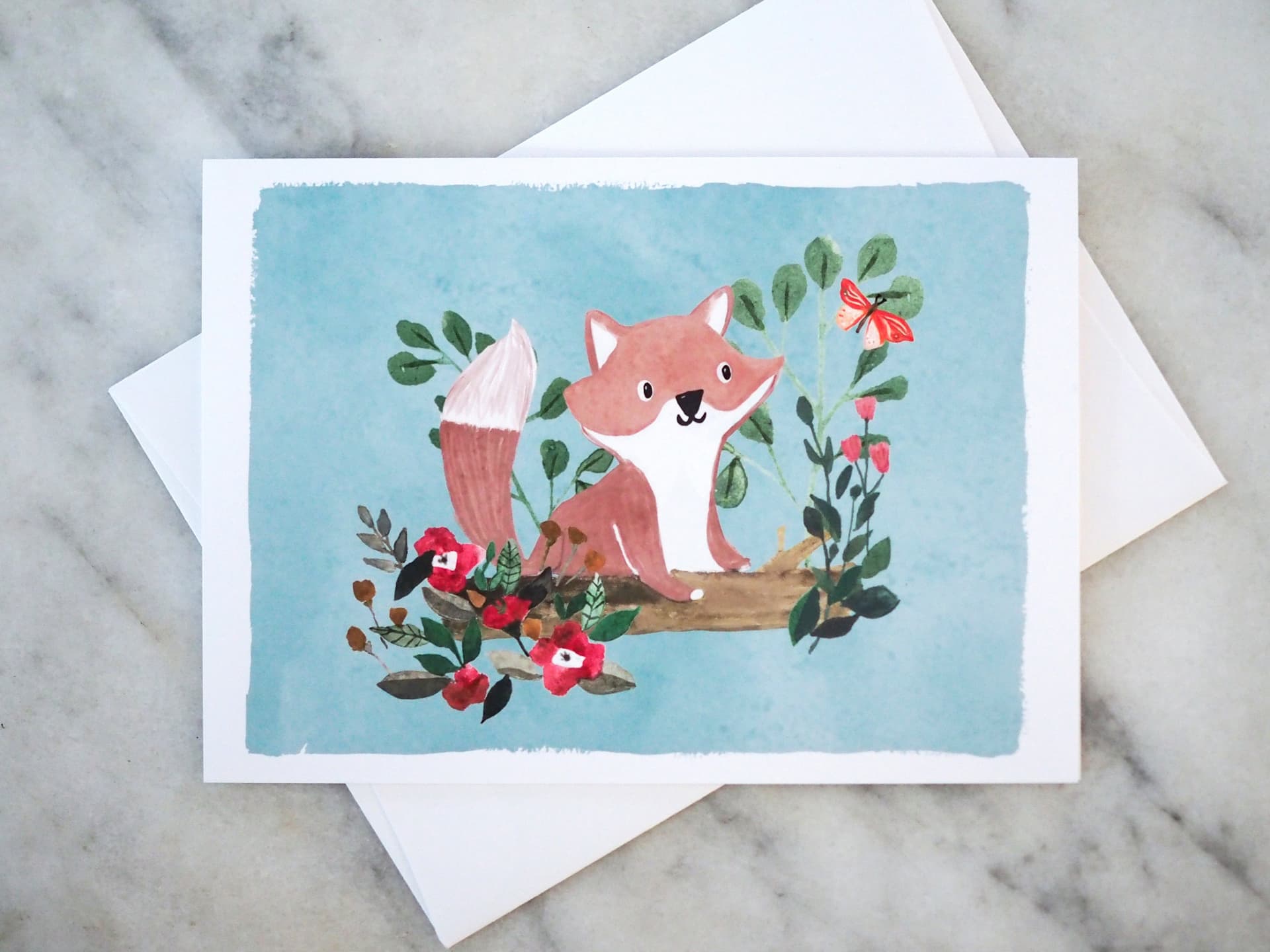 Greeting card with a fox illustration on a marble surface